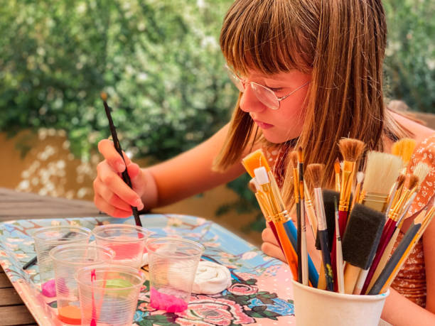 istock Girl doing crafts at home 1327952193