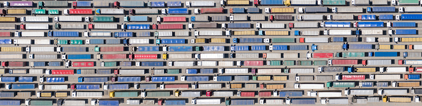 Background, texture or pattern. A huge queue of trucks at the border or terminal. Aerial view.