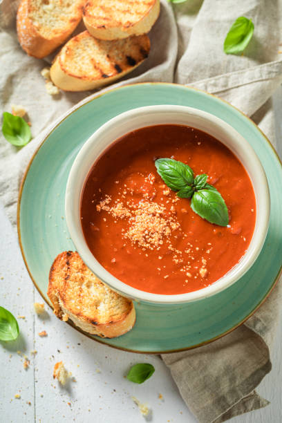 istock Hot tomato soup with toasts and basil. Soup with parmesan 1327956601