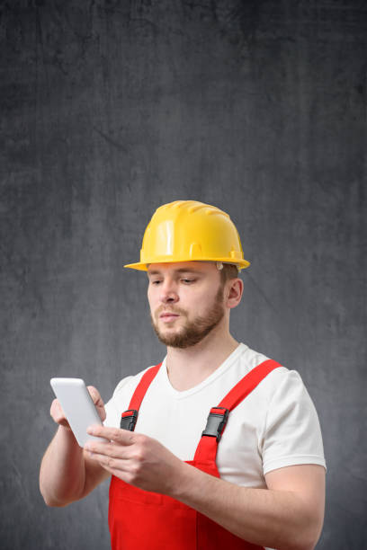 istock Portrait of a worker using his smartphone 1327957916