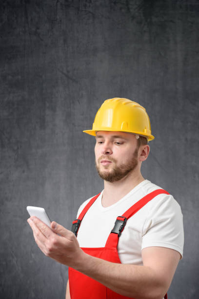 istock Portrait of a worker using his smartphone 1327957933