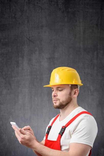 istock Portrait of a worker using his smartphone 1327957962