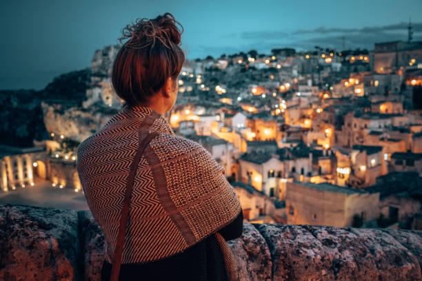 tourist portrait at night matera panorama of the city tourist portrait at night matera panorama of the city murge photos stock pictures, royalty-free photos & images