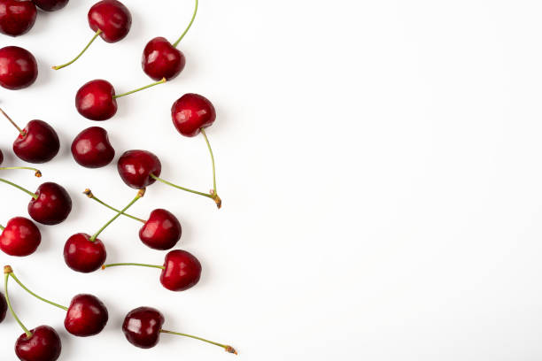 istock Frame of large ripe cherry berries on a white background 1327960950