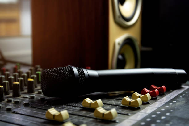 istock Close-up of wireless microphone on sound mixer in recording studio. 1327961138