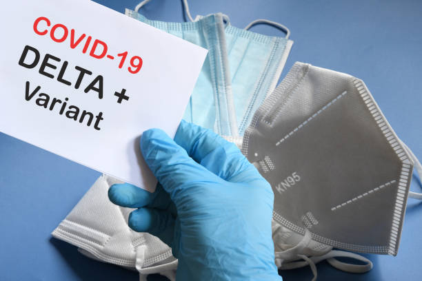 istock Doctor's hand in blue glove with white paper and text Covid-19 Delta + Variant with various protection masks on background. COVID-19 delta variant strain protection concept. 1327961997