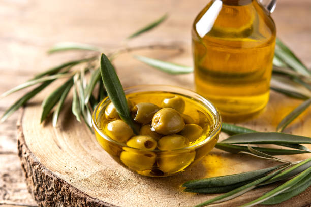 istock Virgin olive oil bottle and green olives 1327962219