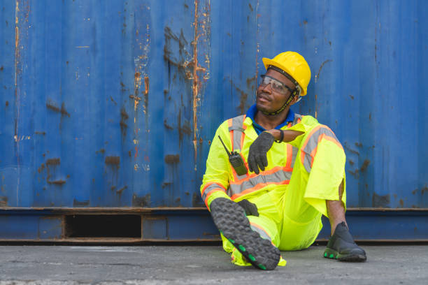 istock Foreman logistic staff sitting relax on the floor at Cargo container shipping 1327965621