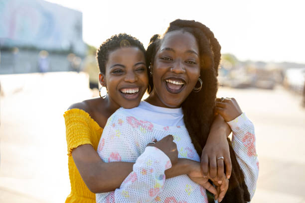 istock Two beautiful happy girlfriends embracing outdoors 1327969305
