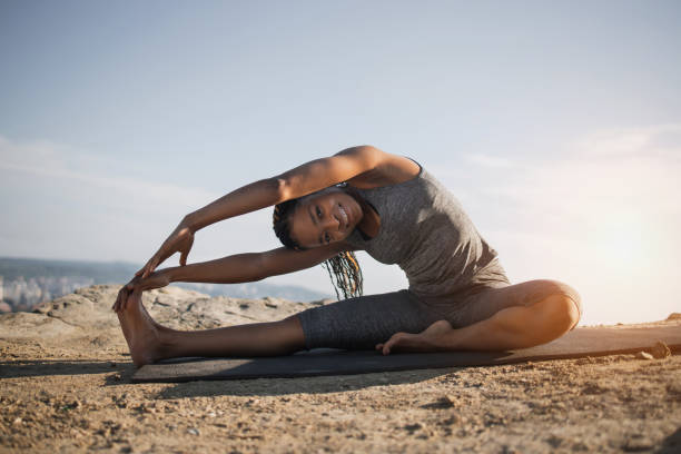 istock Smiling african woman stretching muscles after workout 1327970397