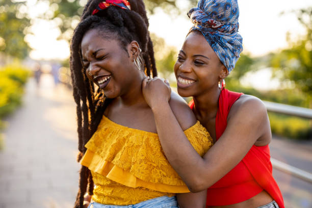 istock Two beautiful happy girlfriends embracing outdoors 1327971632