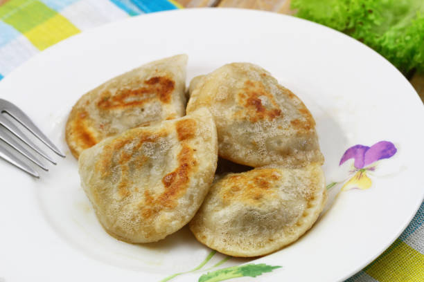 istock Traditional fried Polish dumplings on white plate, closeup 1327975335