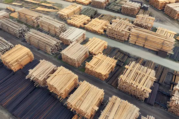 View over an industrial wood production area with many stacks of logs.