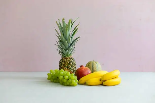 Tropical fruits with a pink background