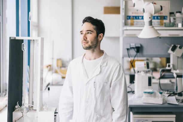 Positive scientist in workplace Portrait of handsome young scientist in laboratory crispr photos stock pictures, royalty-free photos & images