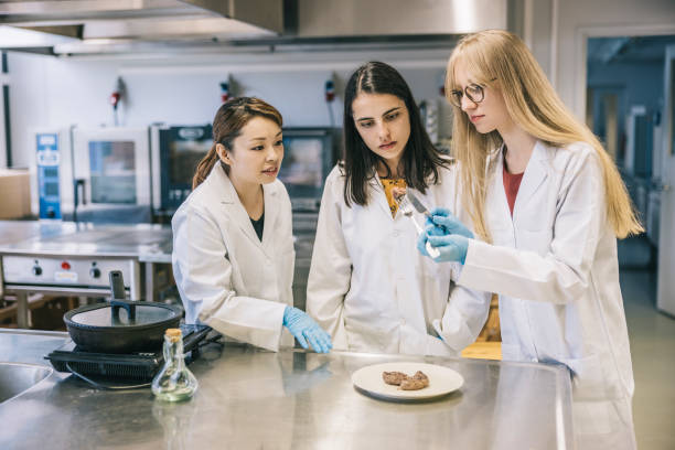 Female scientists looking at fried genetic meat