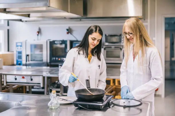 Photo of Two female scientist cooking genetic meat