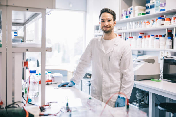 Smiling scientist in workplace stock photo