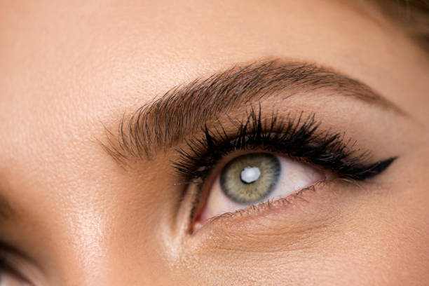 istock Close-up young woman eye with natural makeup 1327981839