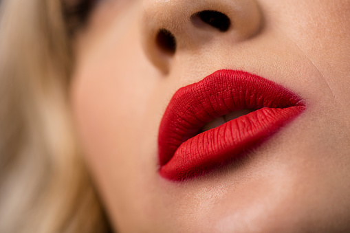 Macro image womans lips with red lipstick on