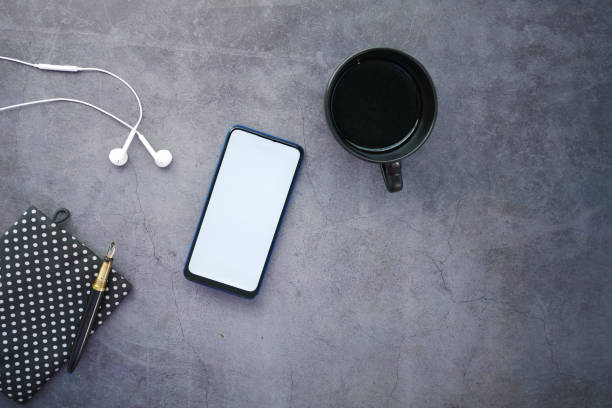 top view of smart phone and ear phone on table