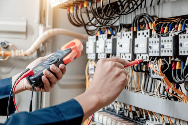 istock Electrician engineer uses a multimeter to test the electrical installation and power line current. 1327986867