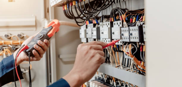 istock Electrician engineer uses a multimeter to test the electrical installation and power line current. 1327986876