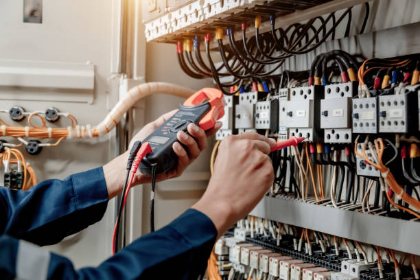 istock Electrician engineer uses a multimeter to test the electrical installation and power line current. 1327986904