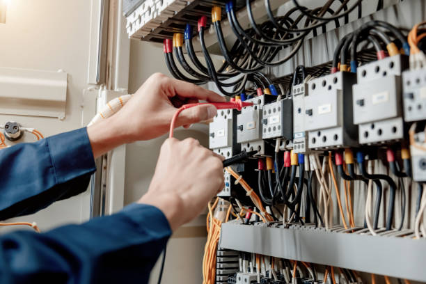 Electrician engineer uses a multimeter to test the electrical installation and power line current. stock photo