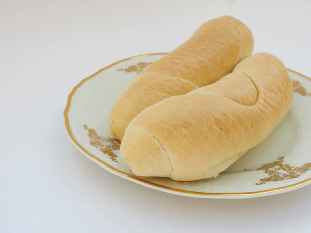 istock Fresh homemade rolls on porcelain plate on white background, selective focus 1327986994