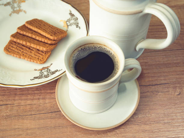 istock Cup of coffee and cookies on the table 1327987162