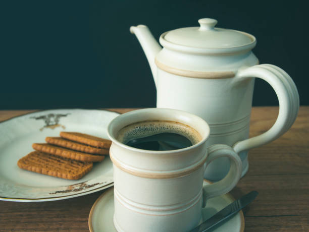 istock Cup of coffee and cookies on the table,blurred background 1327987170