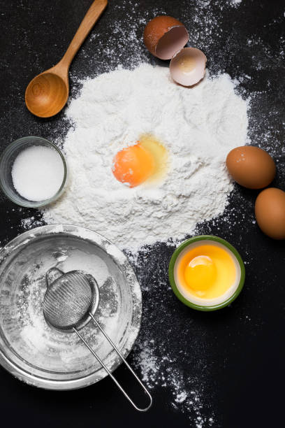 istock Ingredients for baking - flour sugar and eggs on dark background - Top view with copy space 1327989381