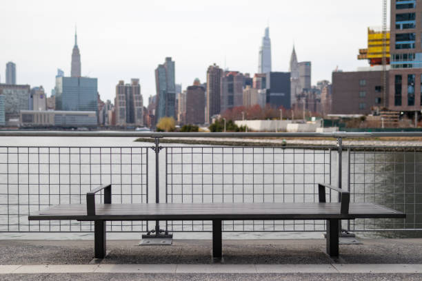 Empty Bench on the Greenpoint Brooklyn Riverfront along the East River with the Manhattan Skyline in the background