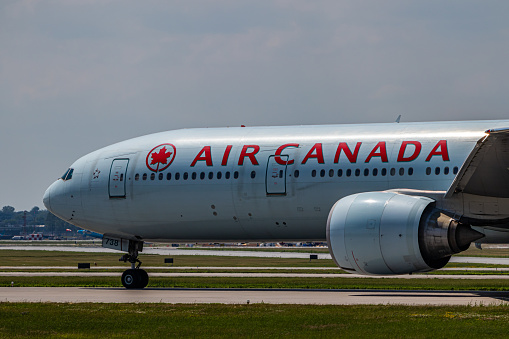 Montreal, Quebec, Canada - 06 27 2021: Air Canada Boeing B777-300 landing in Montreal.