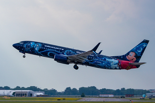 Montreal, Quebec, Canada - 07 07 2021: Westjet's Walt Disney World livery on their 737-8CT taking off from Montreal. Registration C-GWSZ