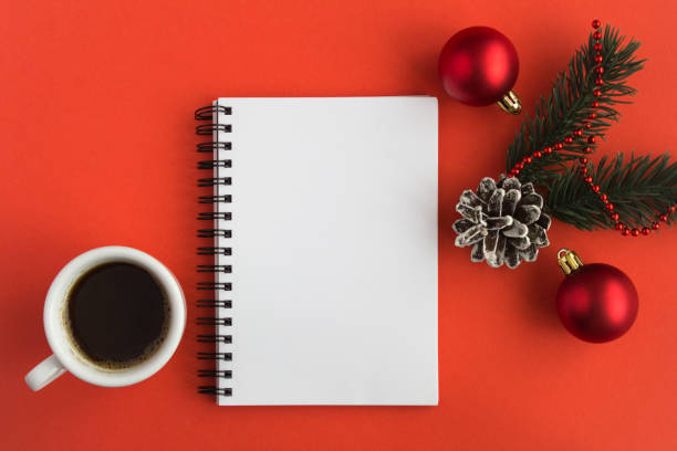 istock Open notepad, black coffee in the white cup and Christmas composition on the red background 1327994564