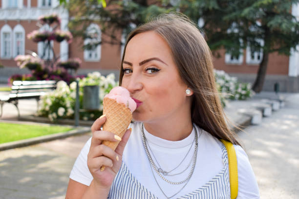 istock Woman outdoors holding ice cream 1327994905