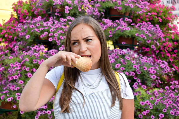 istock Woman outdoors holding ice cream 1327995603