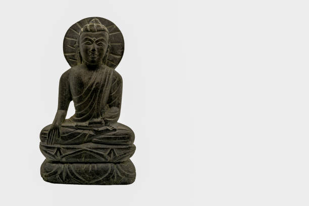 istock Little stone Buddha statue in a sitting meditation posture on white underground 1327997419