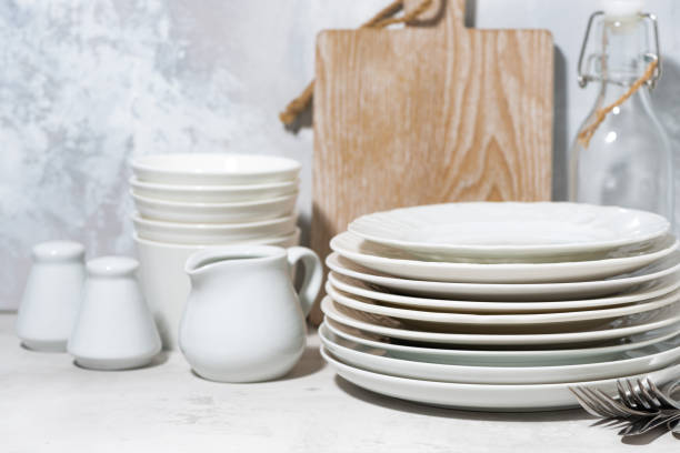 istock clean tableware, cutlery and kitchen utensils on white background 1327999653
