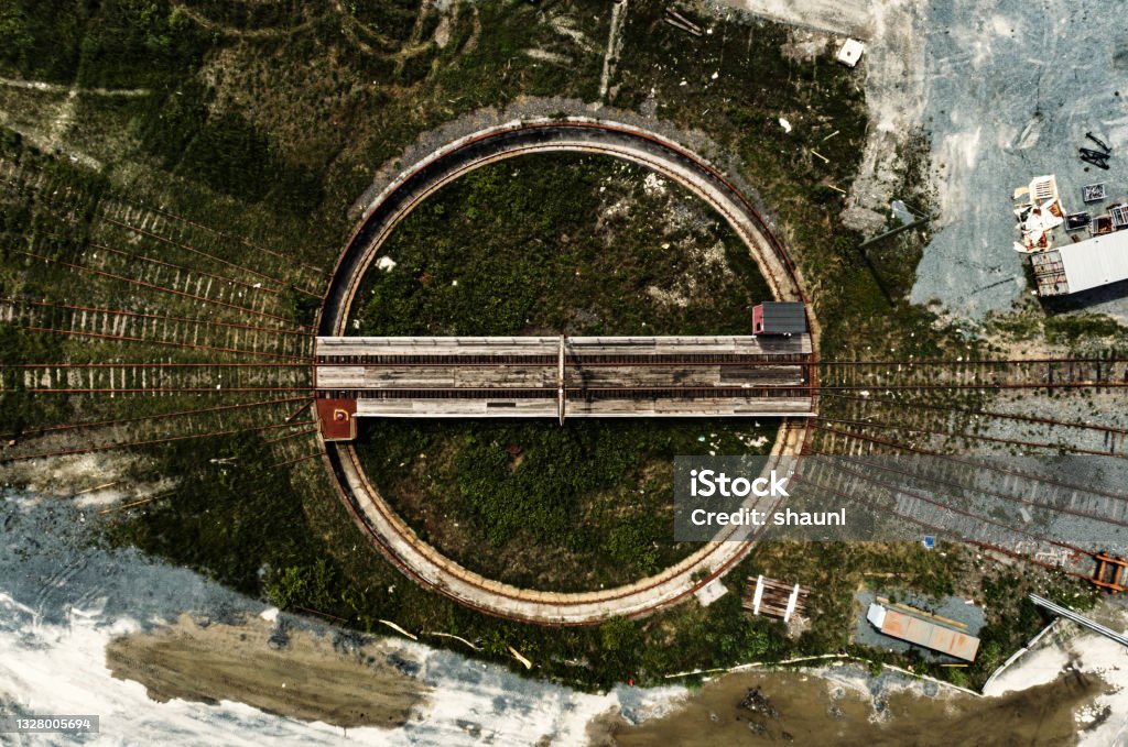 Railyard Turntable A wide angle drone view of a disused turntable in a railyard. Circle Stock Photo