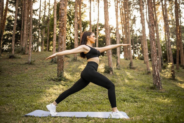istock Young attractive woman practicing yoga, standing in Warrior one exercise, Virabhadrasana II pose, working out, wearing sportswear 1328006536
