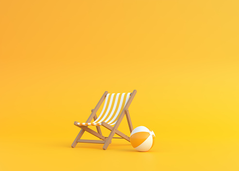 Striped deck chair and beach ball on a yellow background
