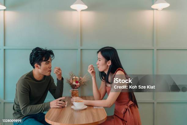 Young Couple Locking Eyes In A Cafe Stock Photo - Download Image Now - Couple - Relationship, Dating, Restaurant