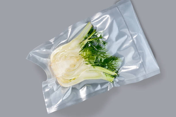 Fennel bulb in vacuum packed Fennel bulb in vacuum packed sealed for sous vide cooking, isolated on grey background vacuum packed stock pictures, royalty-free photos & images