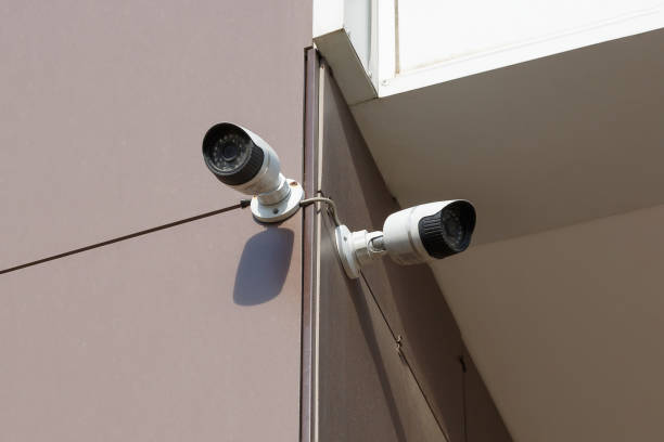 istock Security camera on the wall of an office building 1328011125