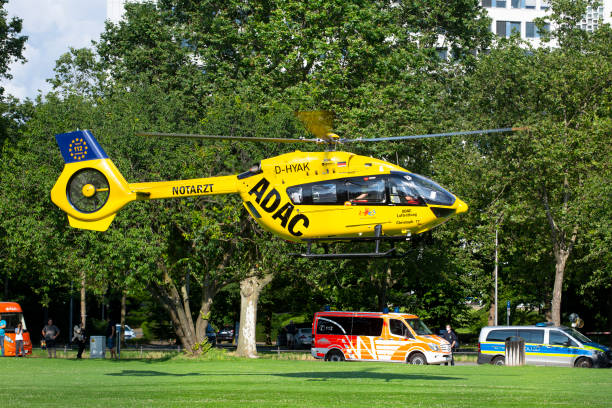 German rescue helicopter Christoph 77 of ADAC air rescue service Wiesbaden, Germany - July 10, 2021: German rescue helicopter Christoph 77 of ADAC air rescue service is taking off from the scene in a recreational park in the city center of Wiesbaden, Germany adac stock pictures, royalty-free photos & images