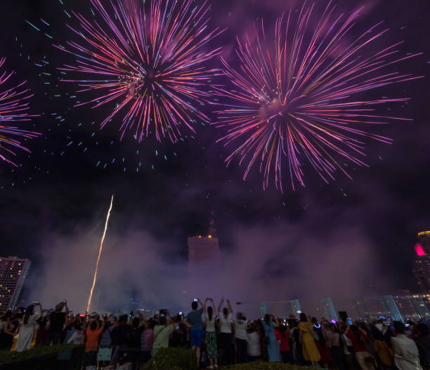 istock Crowd of tourism join New Year celebration with beautiful firework show, Crowd watching fireworks and celebration 1328013616