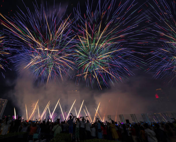 istock Crowd of tourism join New Year celebration with beautiful firework show, Crowd watching fireworks and celebration 1328013665